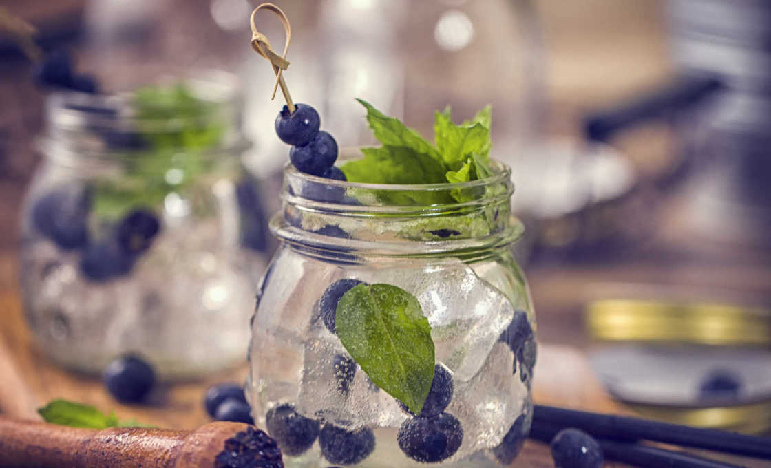 Blueberry Mint Mojito on a wooden serving platter with blueberries