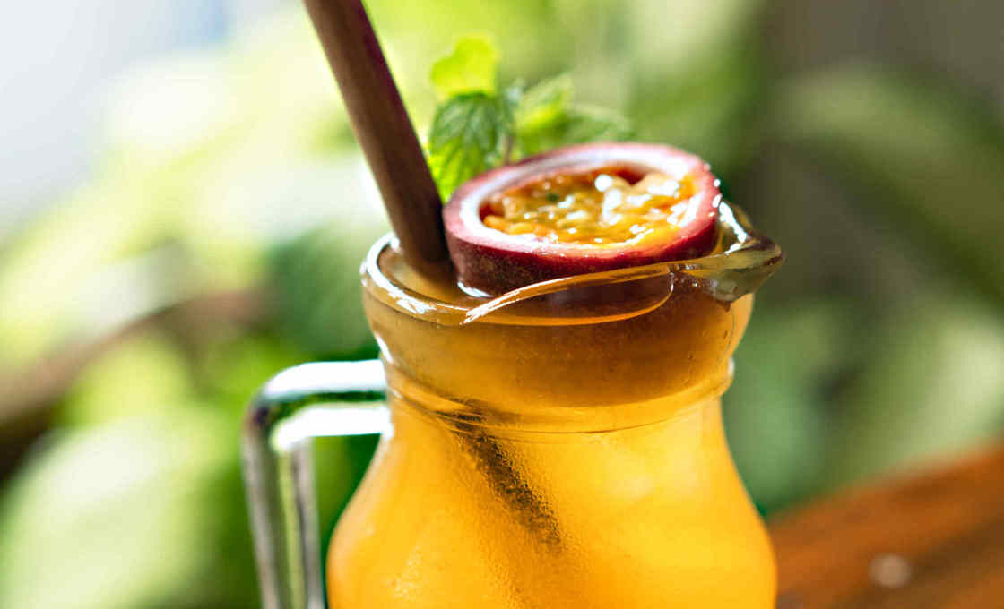 A glass of orange and passion fruit soda on a transparent background