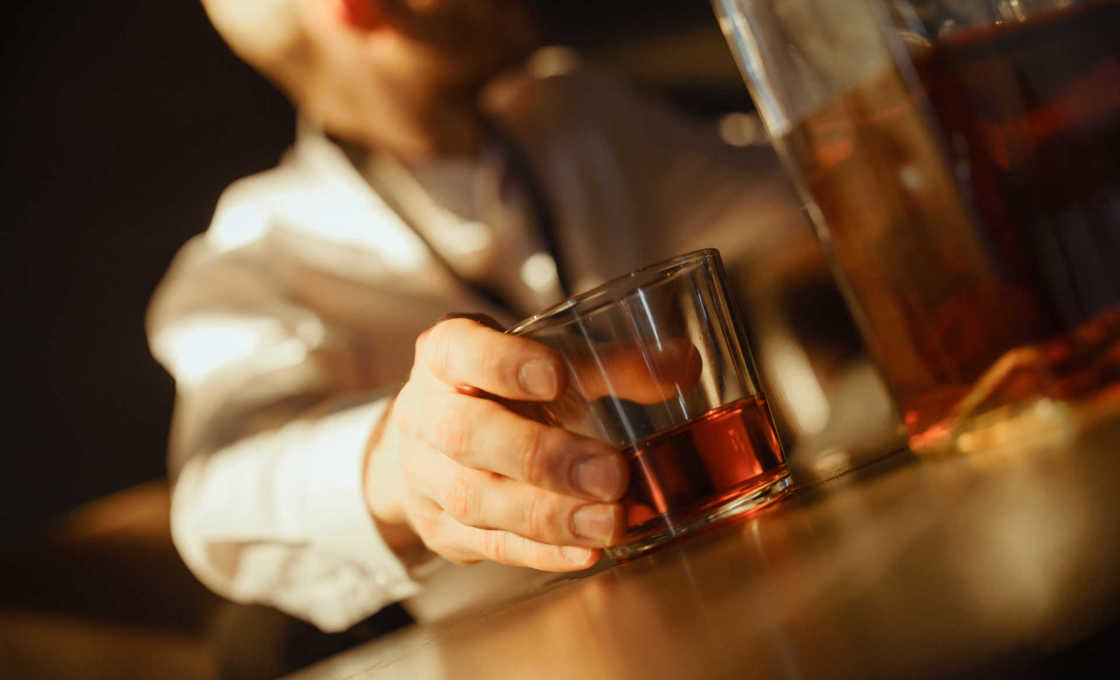 bartender placing a glass of Brandy Mint Shot on a counter