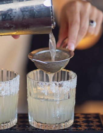 pouring juice through strainer