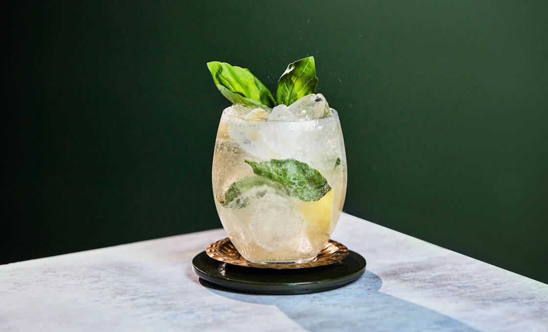 Fresh Lemon Basil Spritzer cocktail with mint on a wooden table