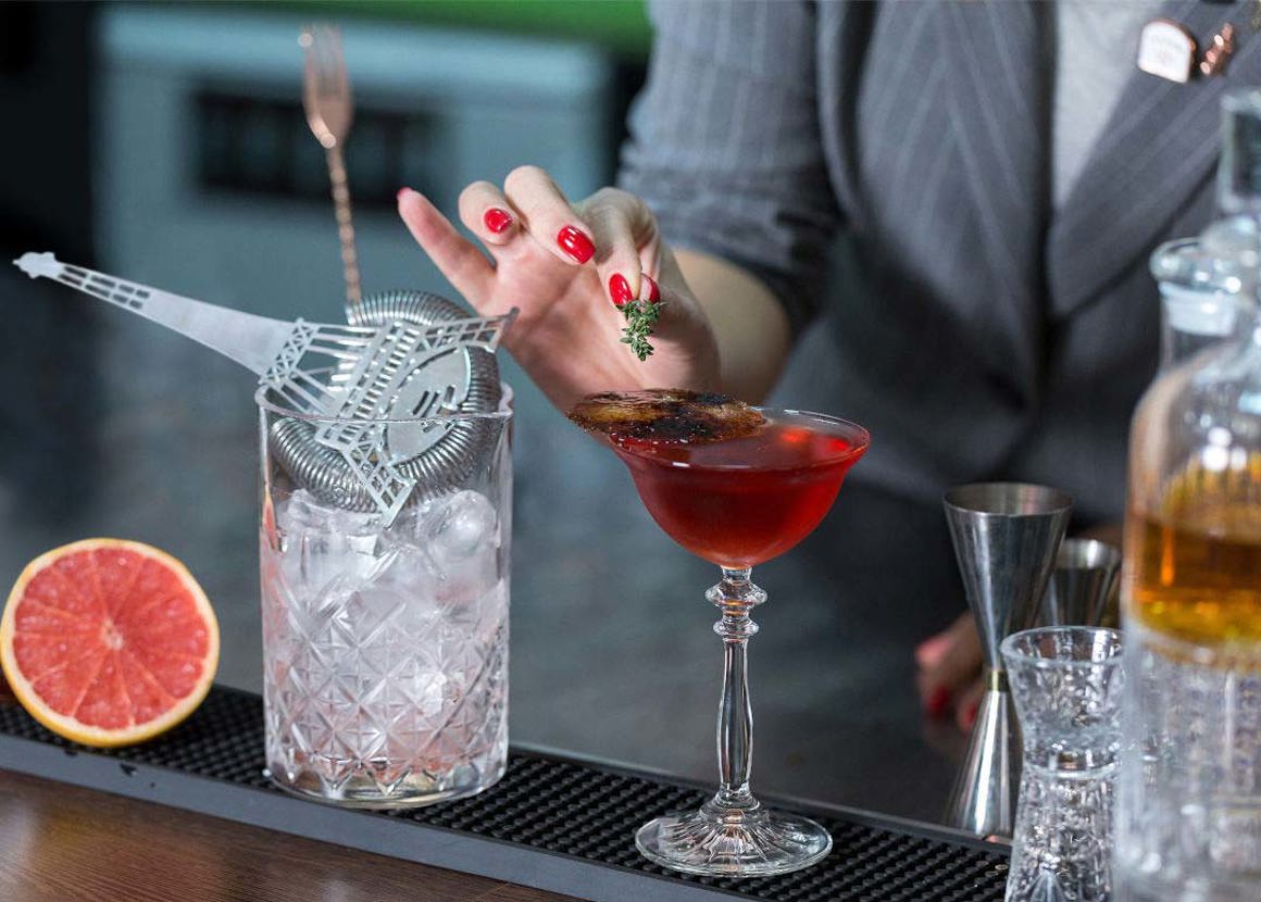 Bartender garnishing a drink