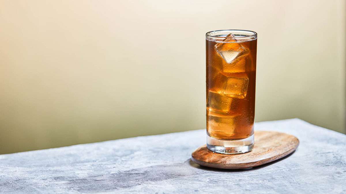 Glass of Apple Iced Tea on a wooden serving plater