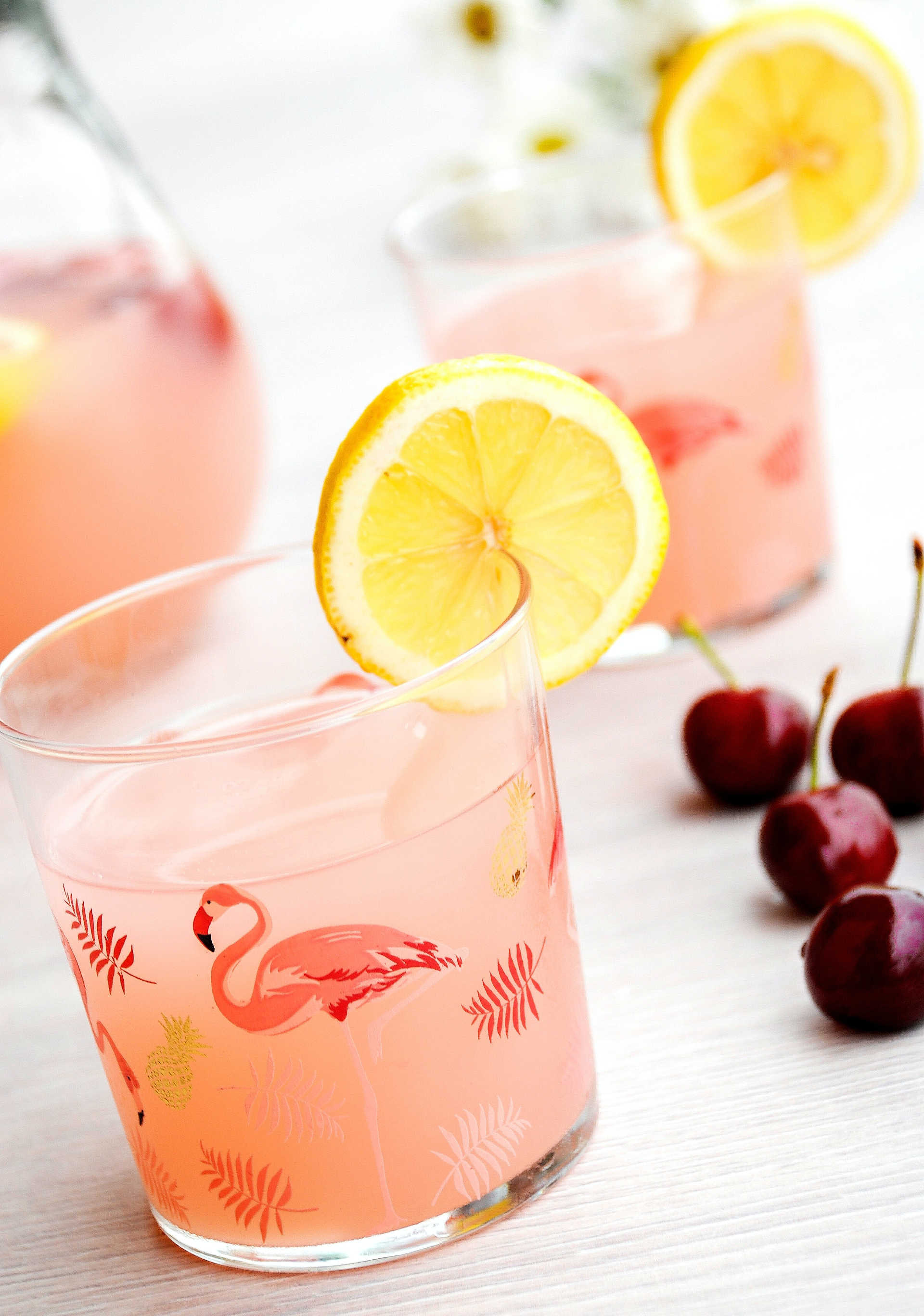 Sunrise cocktail in a flamingo glass with cherries 