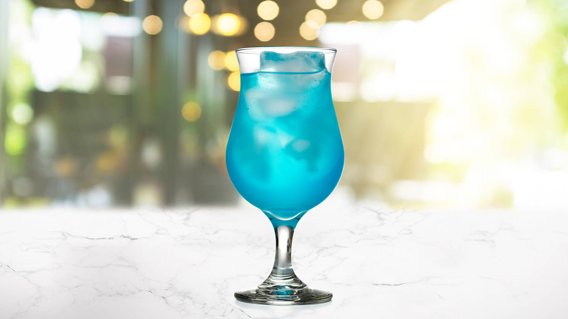 Glass of Blue Star on a marble surface