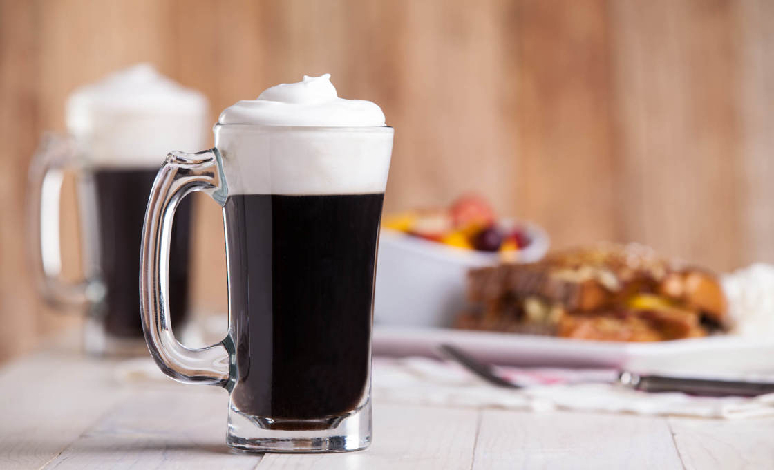 Two glasses of Rosemary Irish Coffee with whipped cream on top