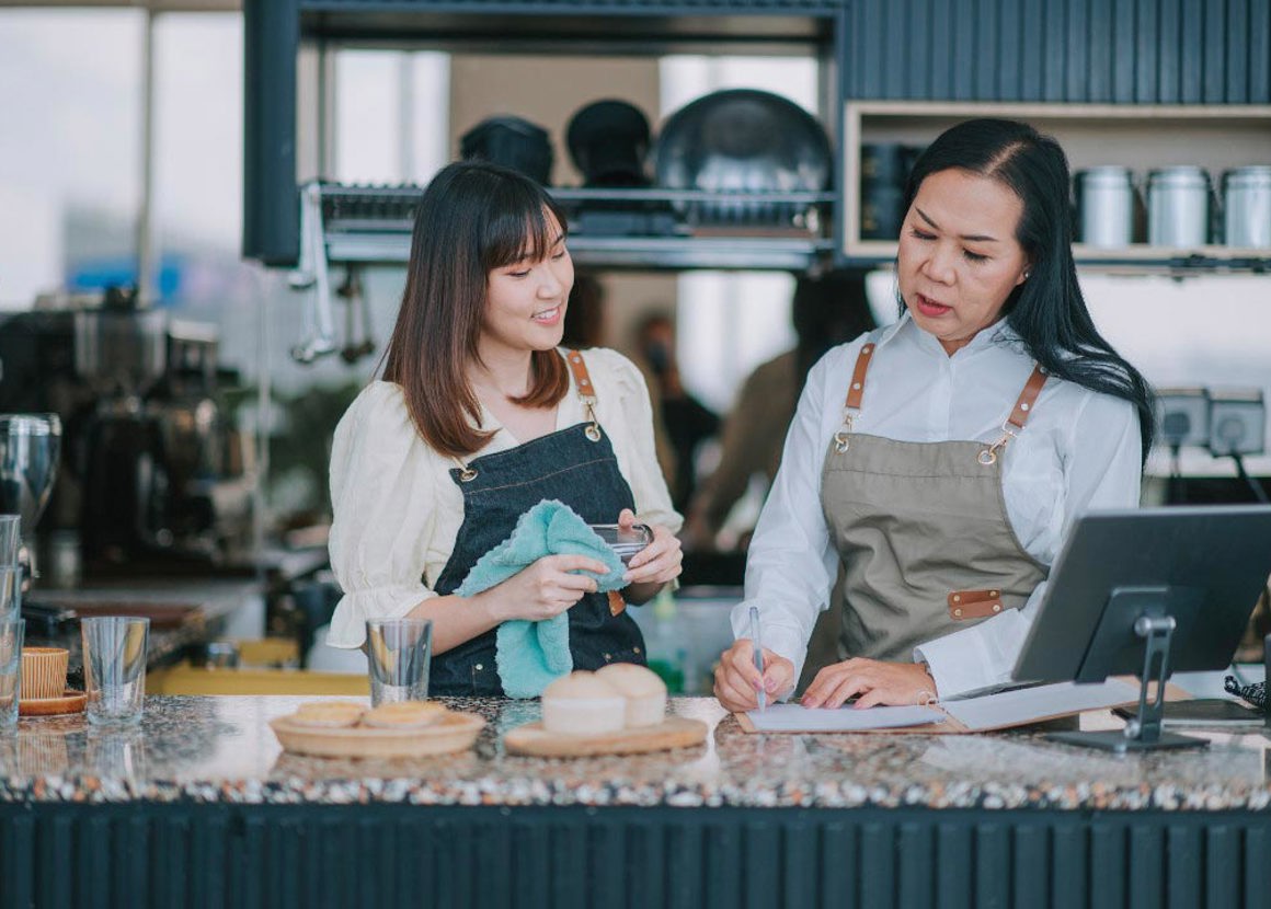 Two bartenders doing admin