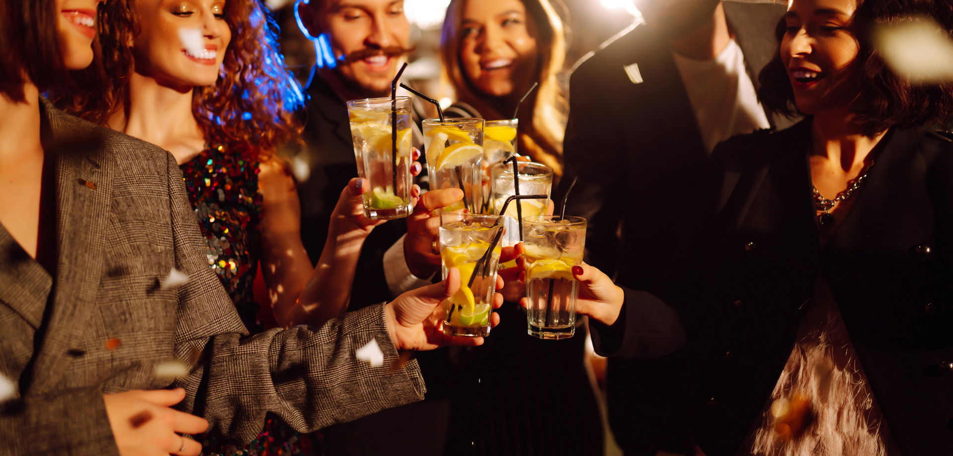 People in a group, celebrating with drinks 
