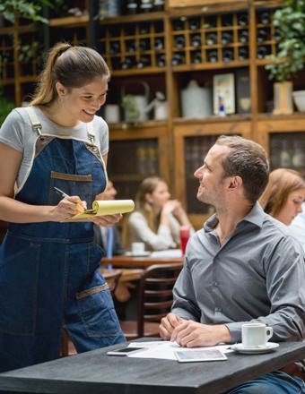 Waitress Serving Man At A Restaurant