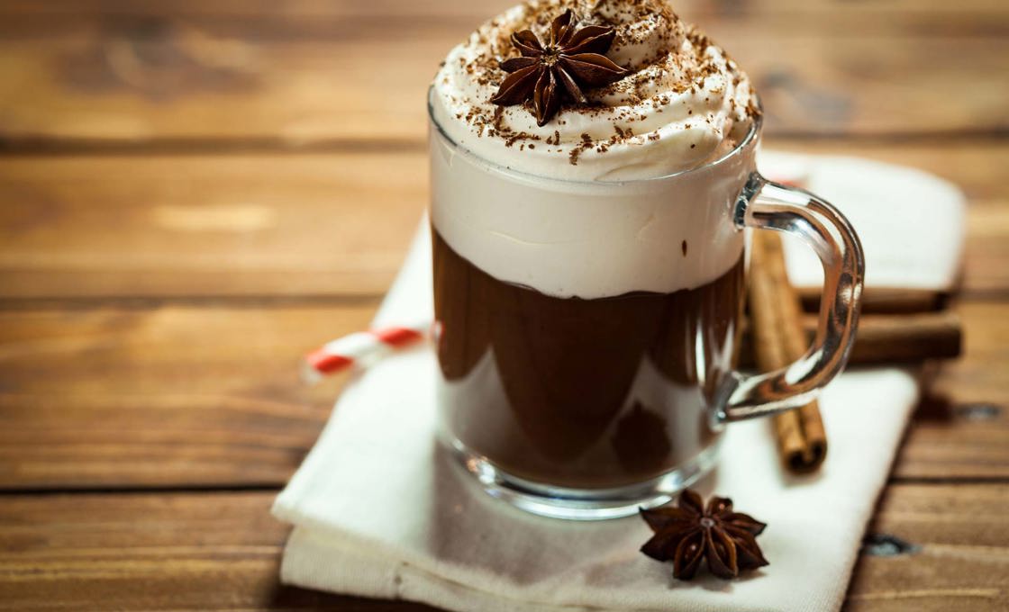 A glass of hot cocoa anise with chocolate sprinkled on top