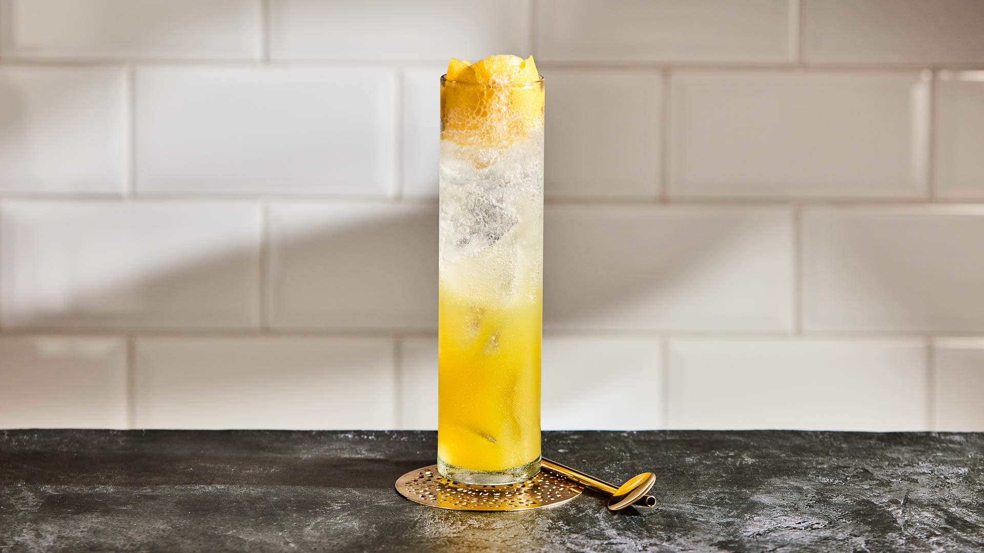 Cactus Pineapple Punch on a dark stone surface against a white tile wall
