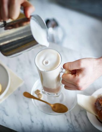 pouring milk into coffee