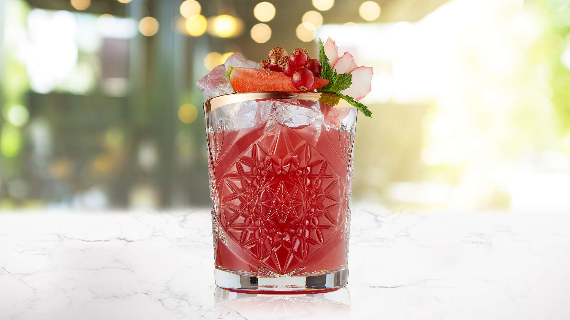 Rhubarb berry punch in a detailed glass