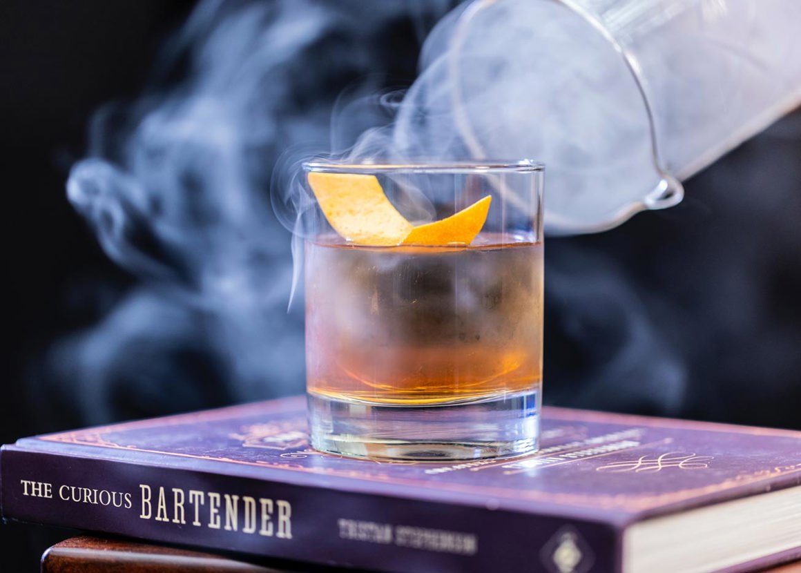 dry ice cocktail on books with smoke effect