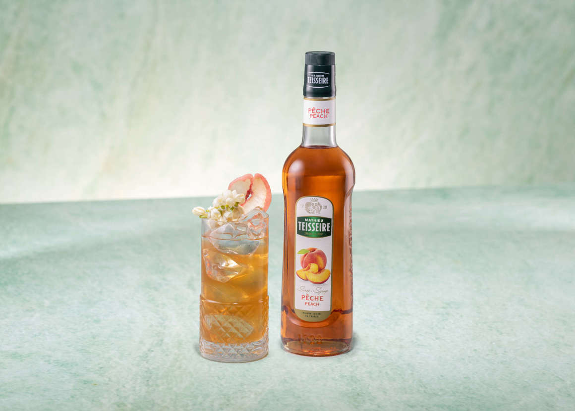 Peach & Jasmine Iced Tea with a bottle of Mathieu Teisseire peach syrup