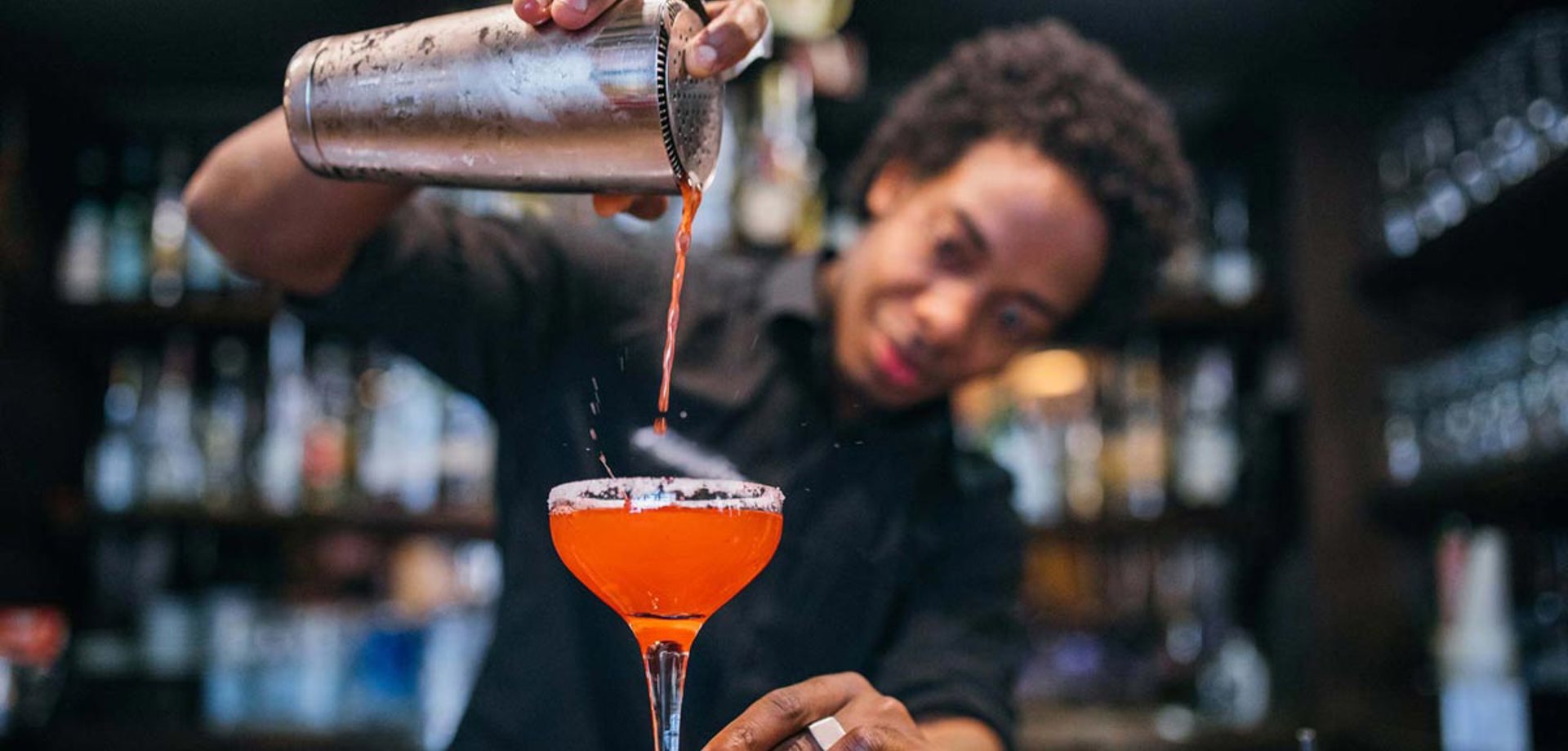 Young Bartender Pouring Cocktails In A Cocktail Bar