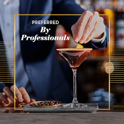 Preferred by professionals - man in suit garnishing cocktail