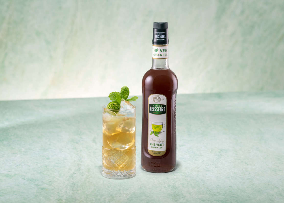 Emerald Green Iced Tea with a bottle of Mathieu Teisseire Green tea syrup