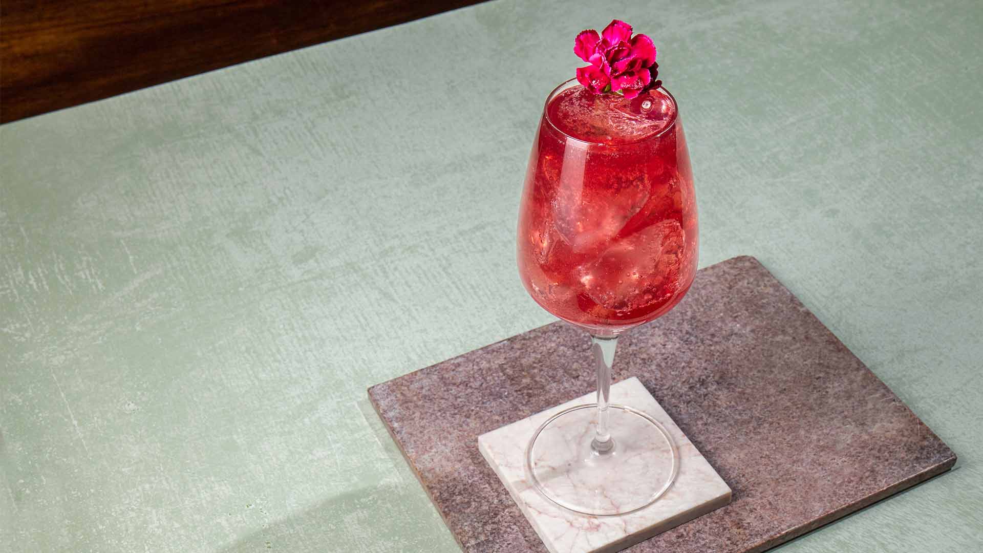 a glass of High & Dry Hibiscus Spritz