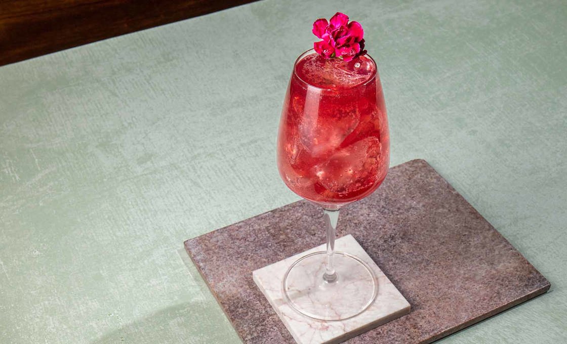 a glass of High & Dry Hibiscus Spritz